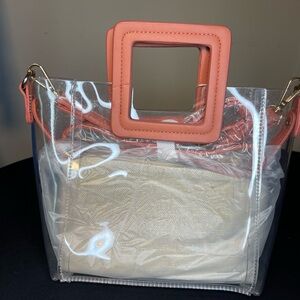 Clear, coral colored handbag with removable straps great for concerts/events.